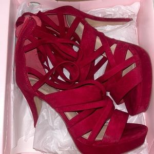 Tall Red suede heels small Knick on the heel see picture #3. (Barely noticeable)